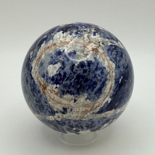 Sunset Sodalite sphere showing the rust orange ring