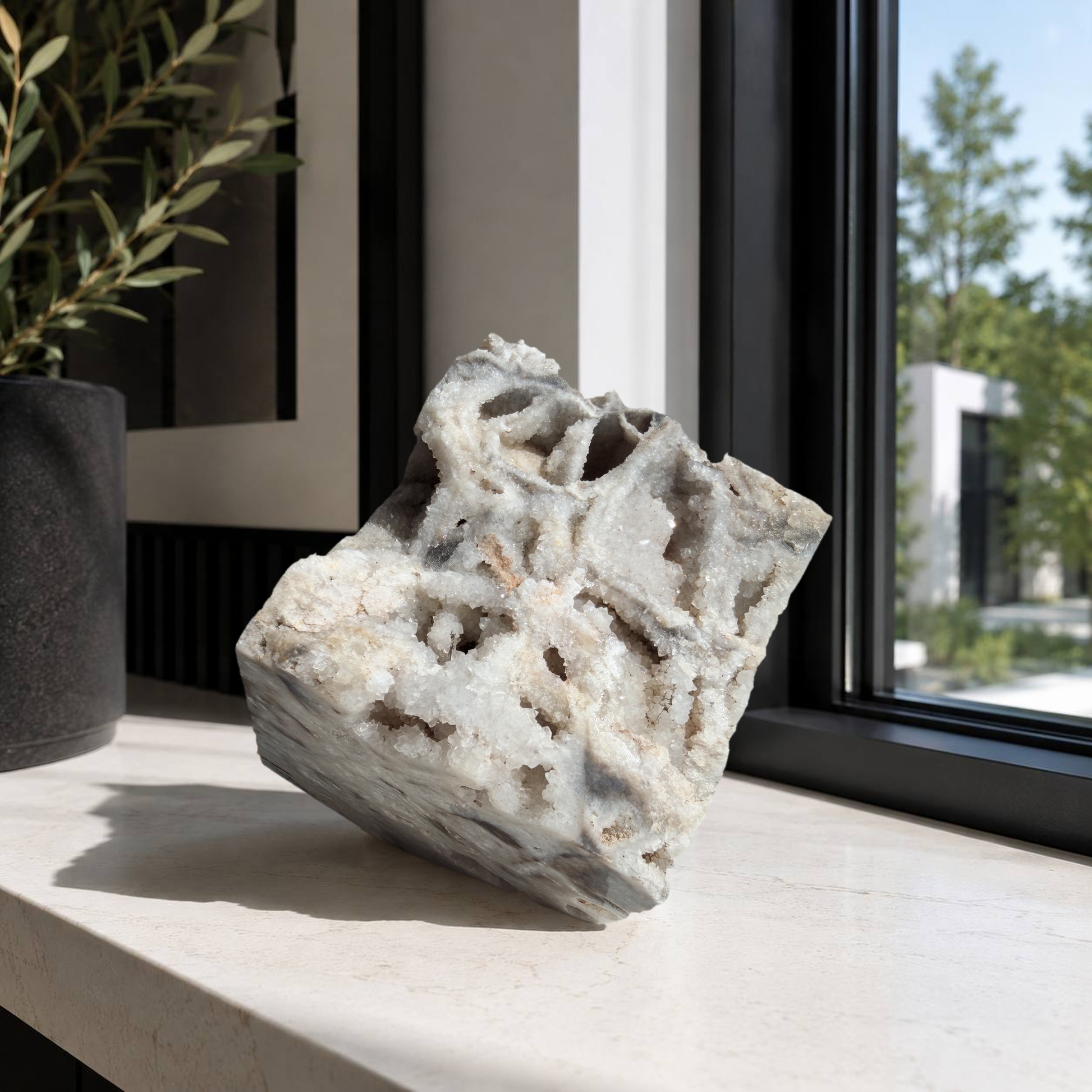 Druzy quartz boxwork specimen on a sunlit ledge