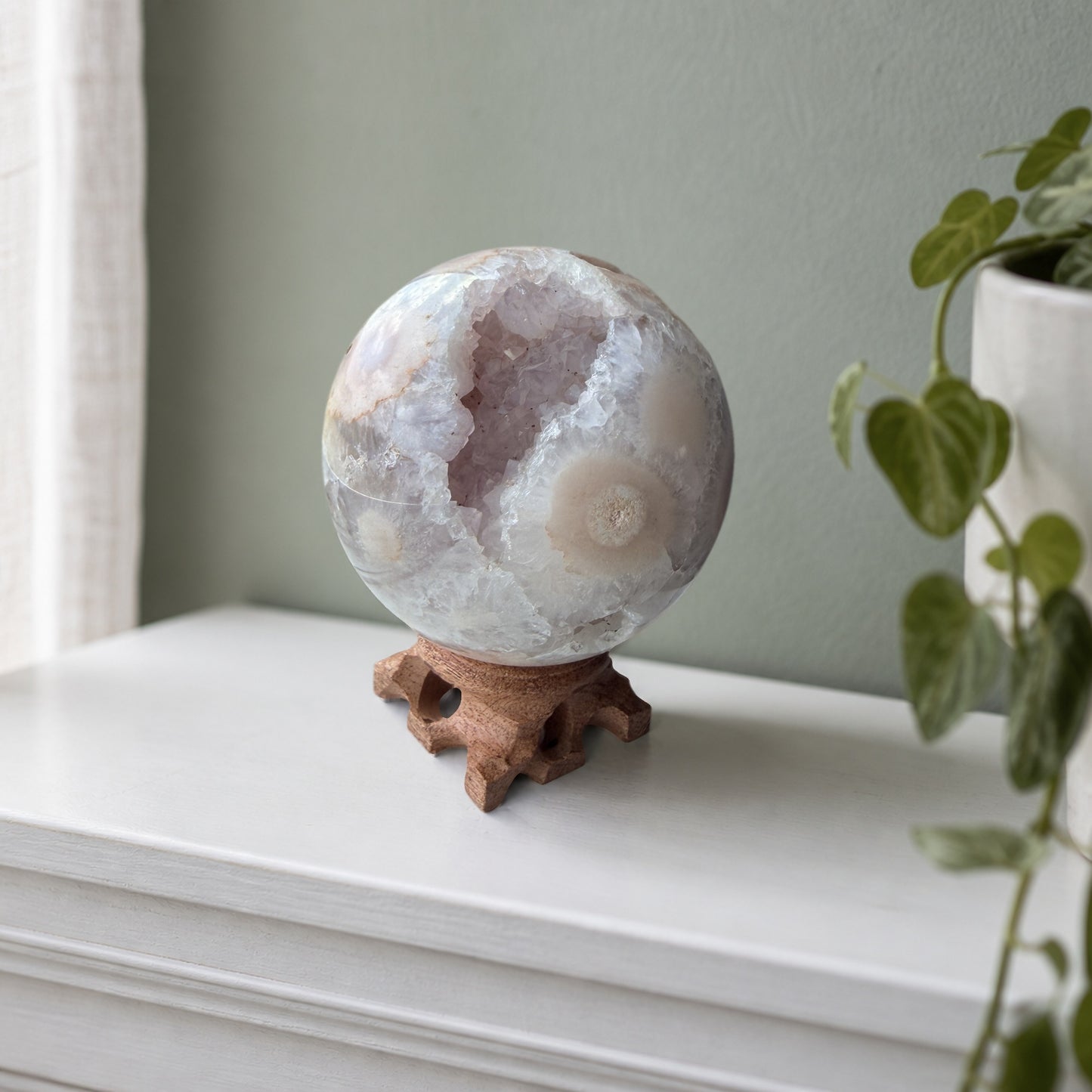 Flower agate sphere with druzy geode pocket