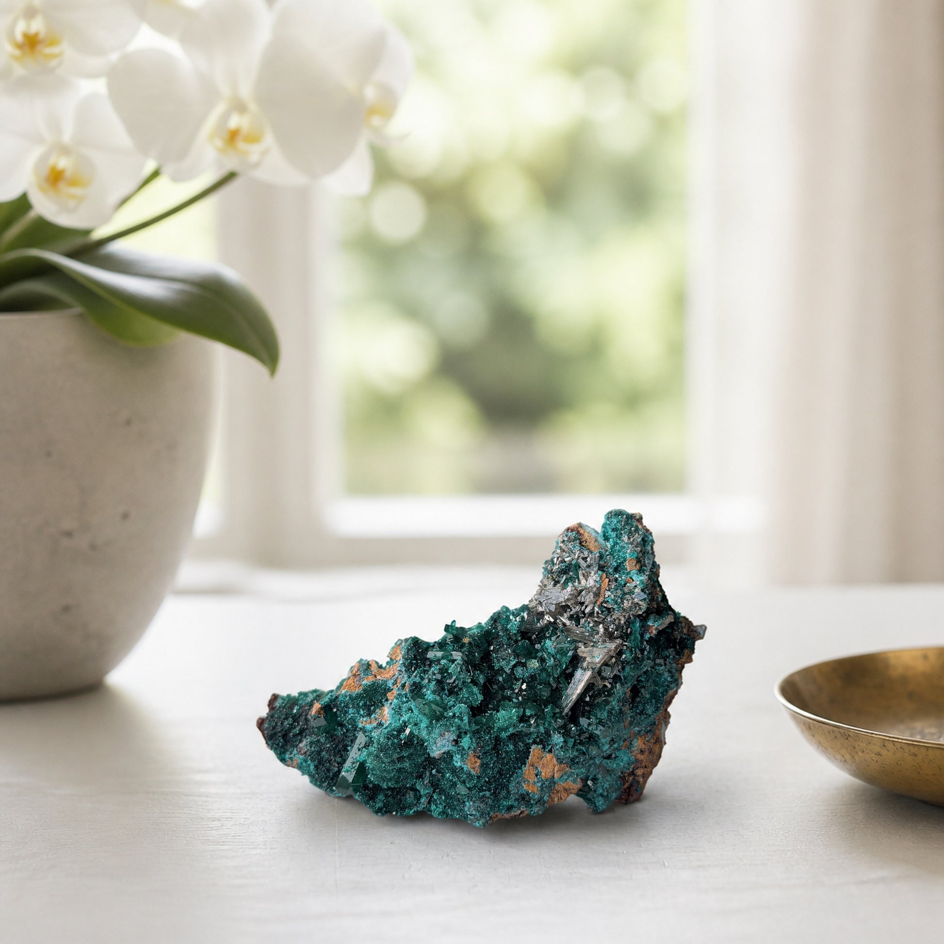 Dioptase specimen with silvery blades