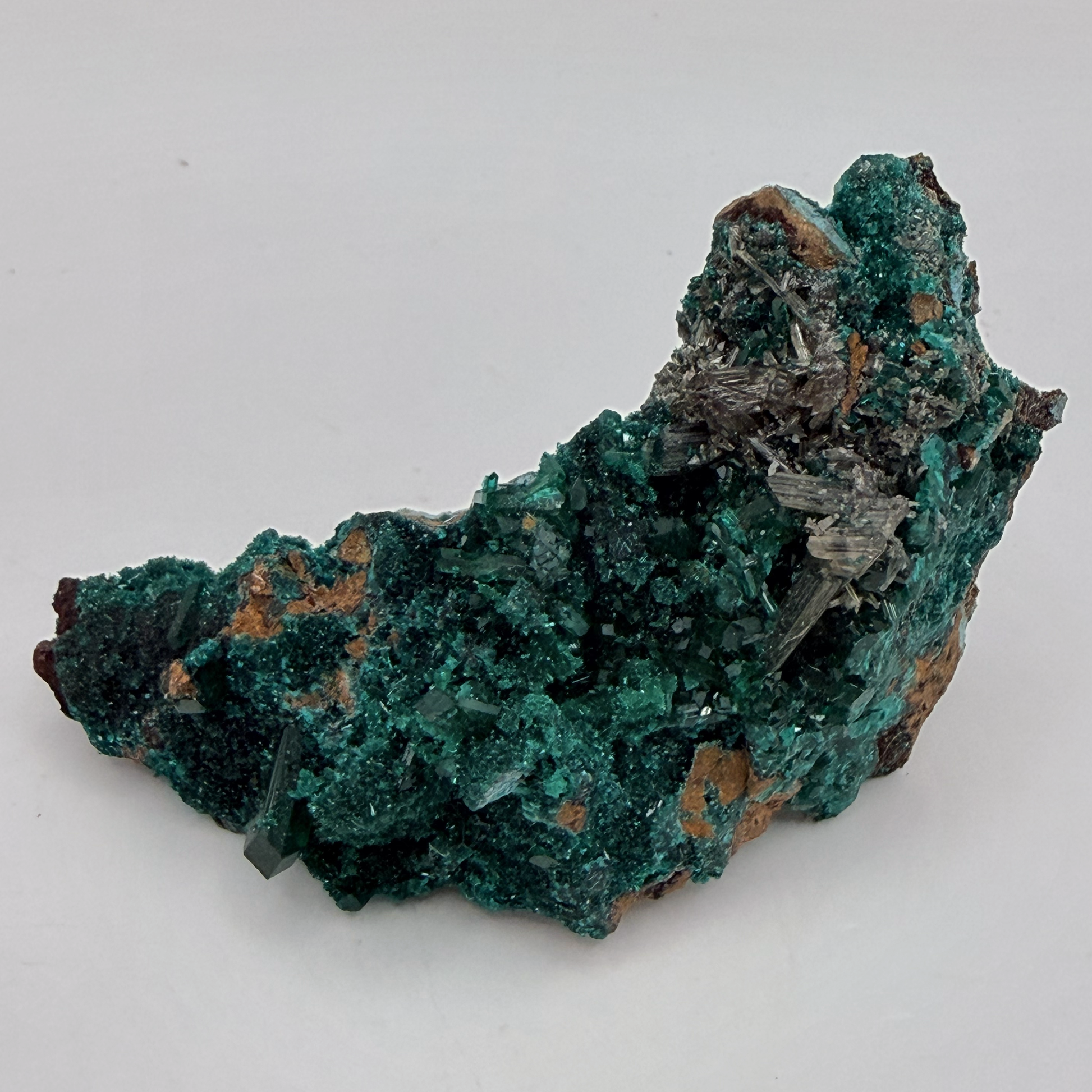 Dioptase specimen with silvery blades