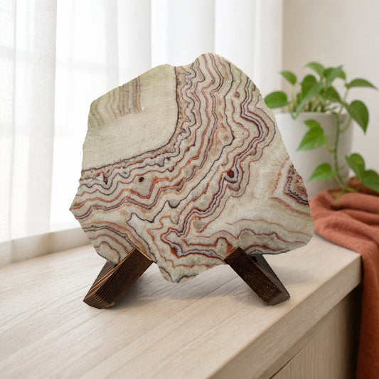 Banded calcite slab on wooden X stand