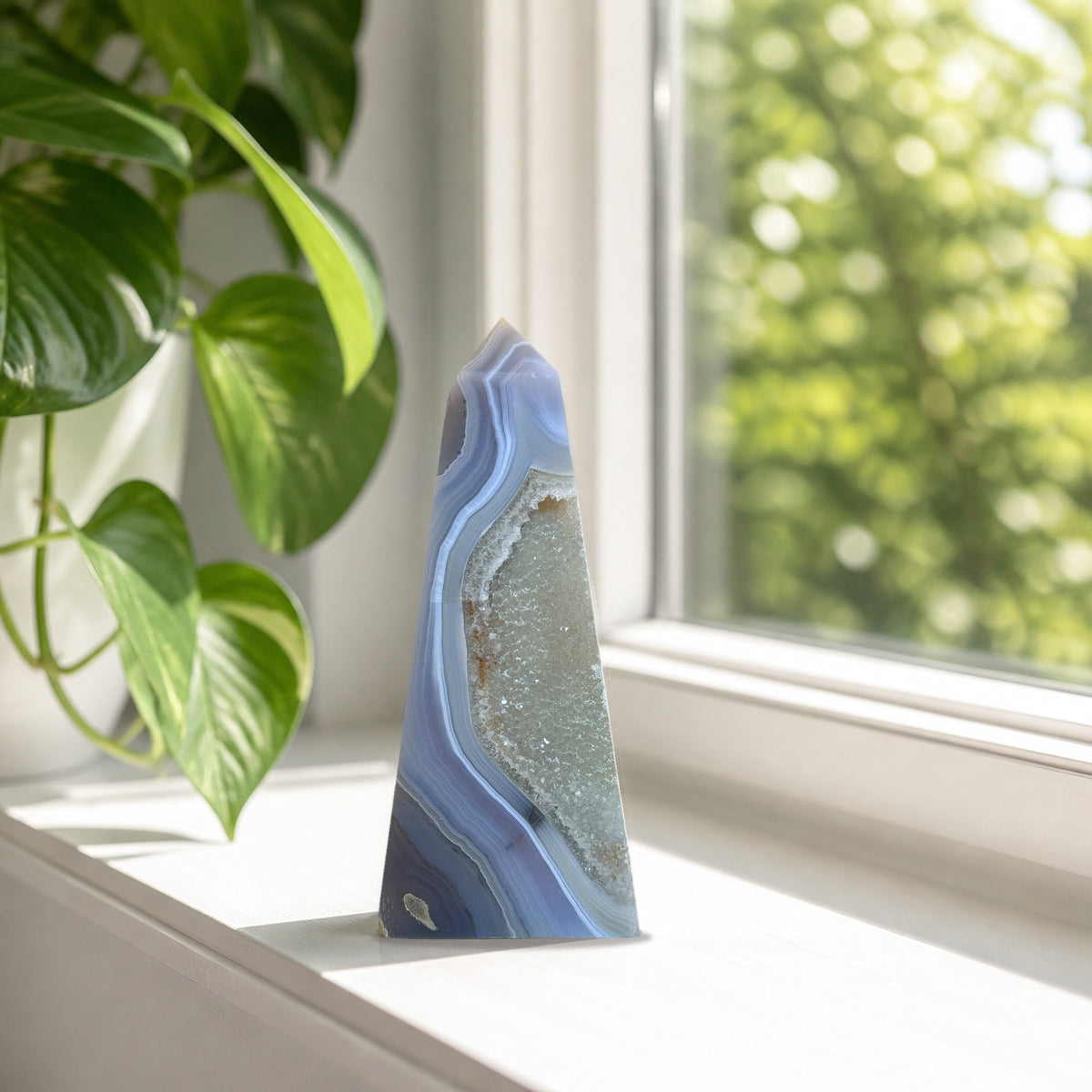 Blue banded agate obelisk with druzy quartz pocket
