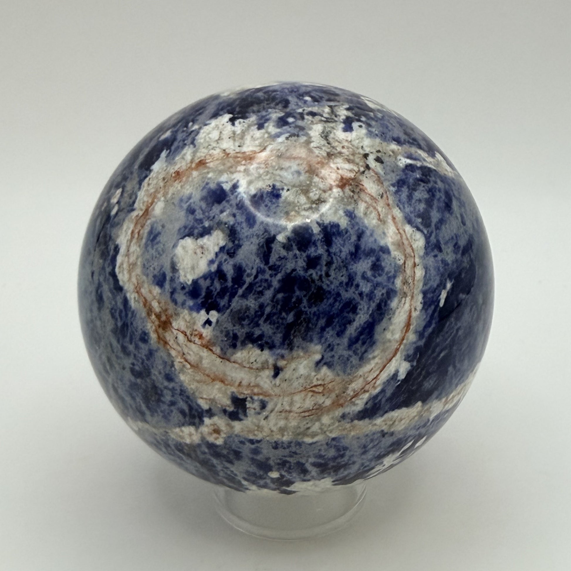Sunset Sodalite sphere showing the rust orange ring