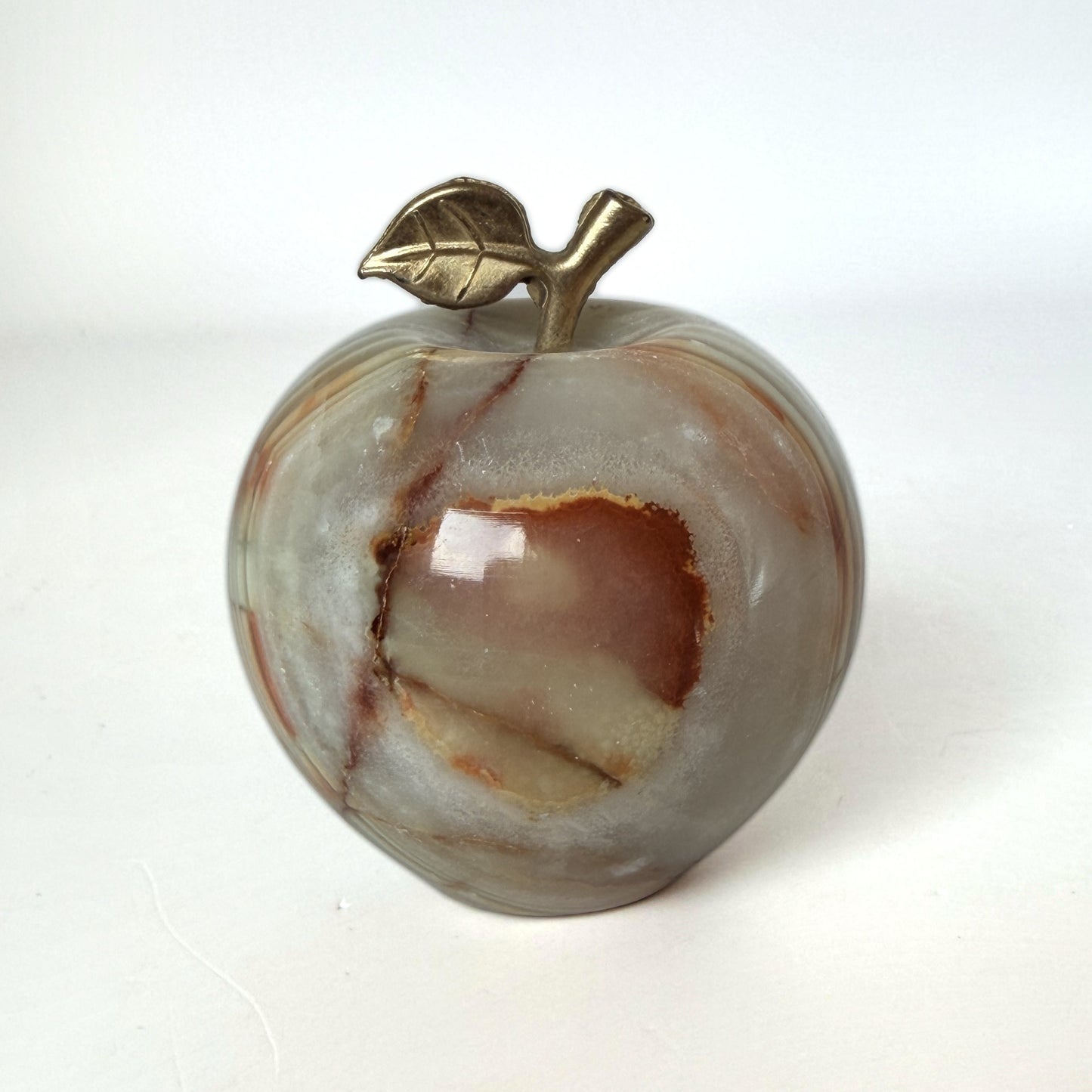 Carved onyx apple with brass leaf and stem, front view