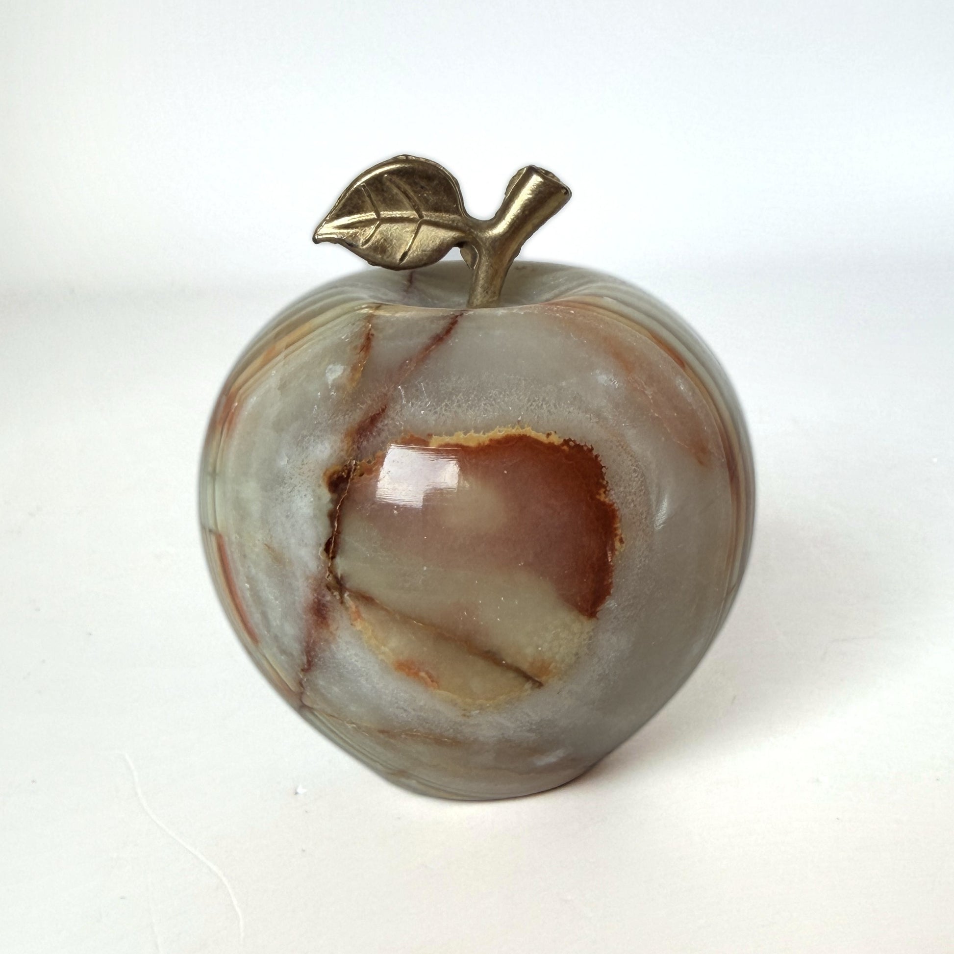 Carved onyx apple with brass leaf and stem, front view