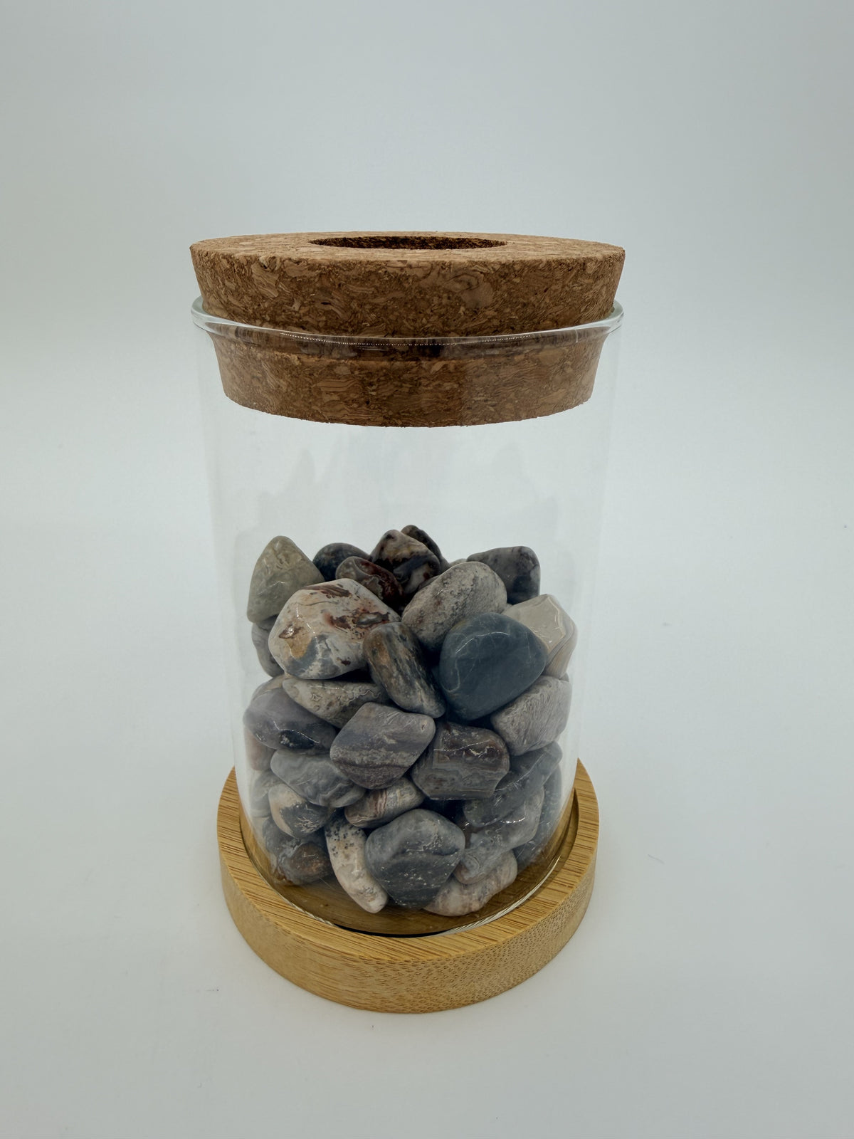 Gray toned crazy lace agate propagation station with glass vase, cork ring, and bamboo coaster