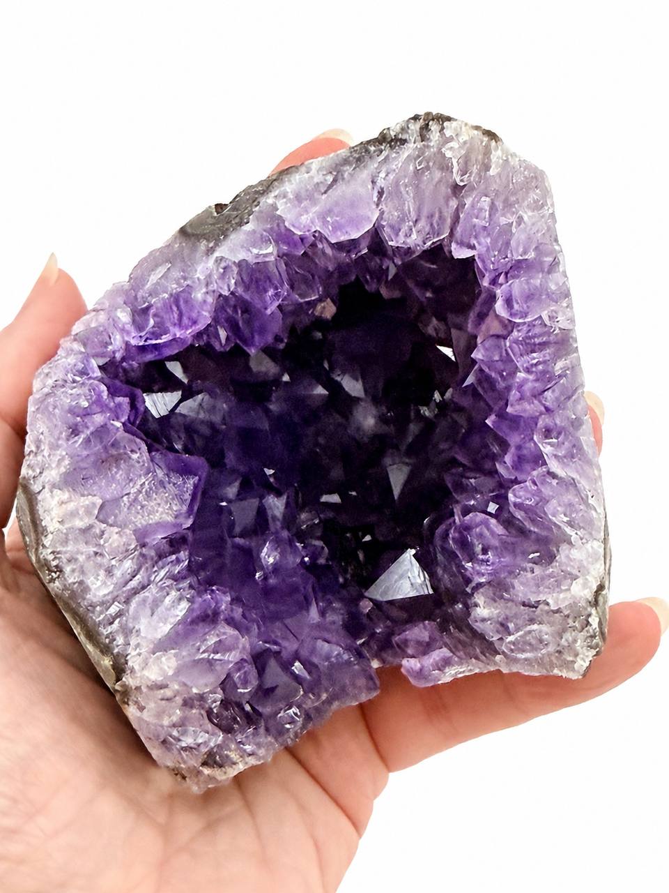 Uruguay Amethyst Geode Cave, hand held front view showing deep purple crystals