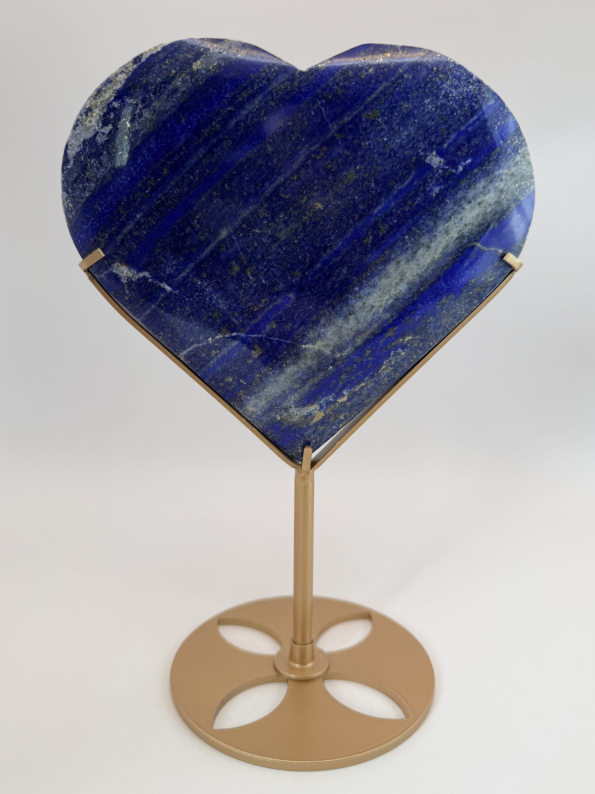 Lapis lazuli heart on gold stand, on stand