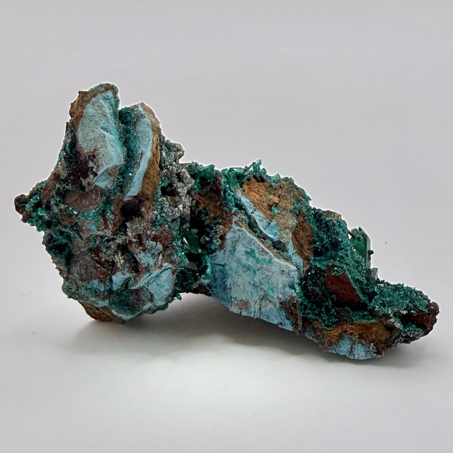 Dioptase specimen with silvery blades