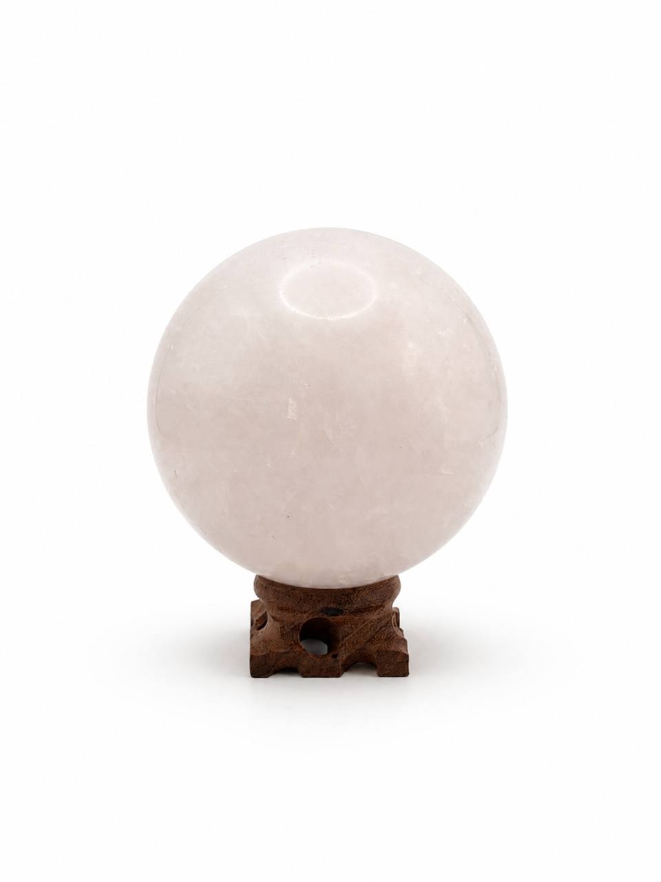 Rose Quartz Sphere on carved wooden stand, front view