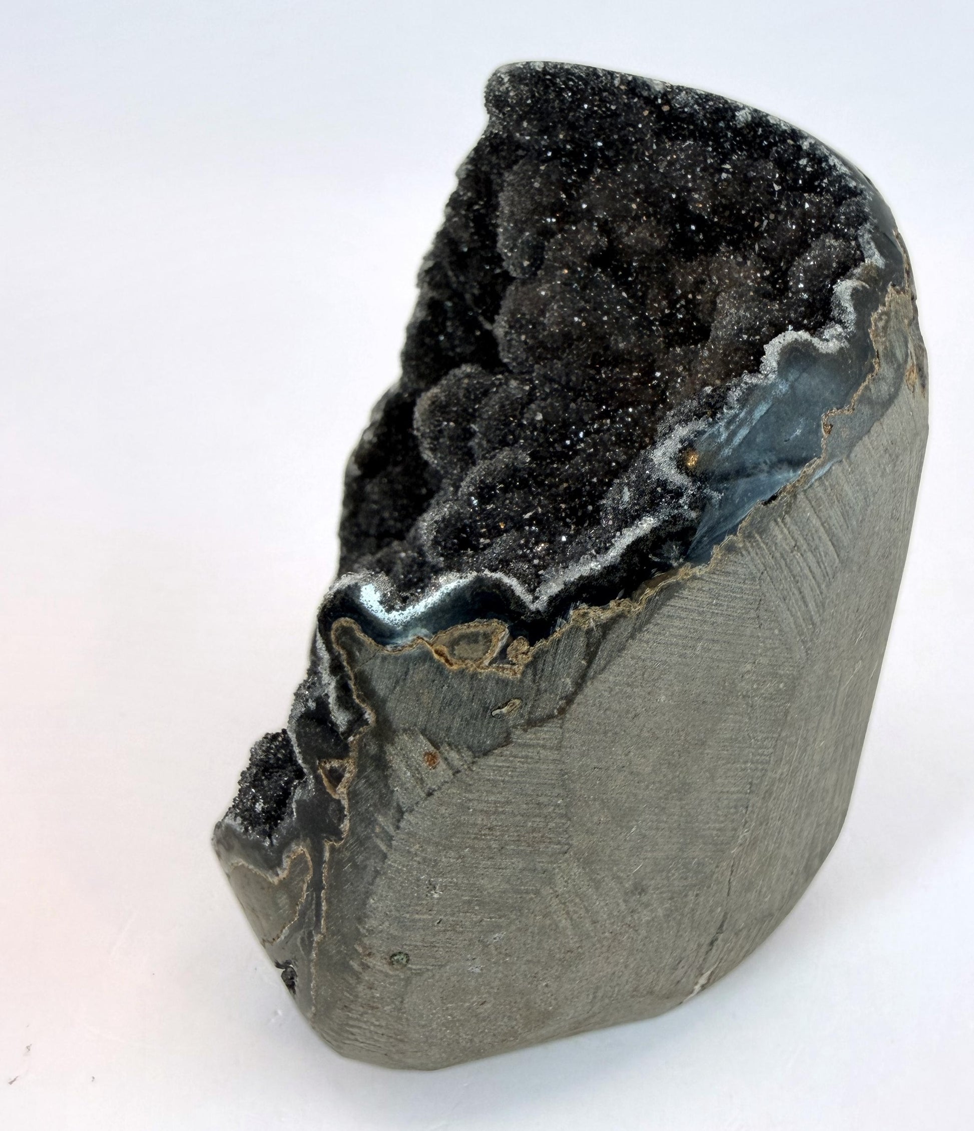 Side view of the druzy geode showing the agate rim and rock exterior