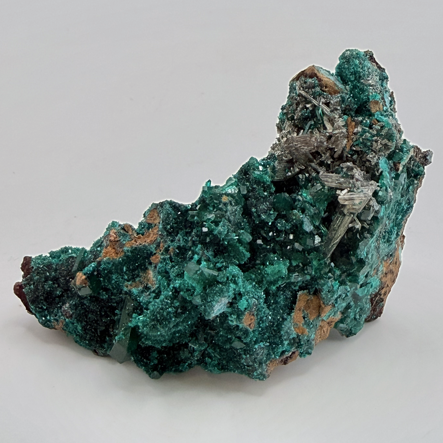 Dioptase specimen with silvery blades