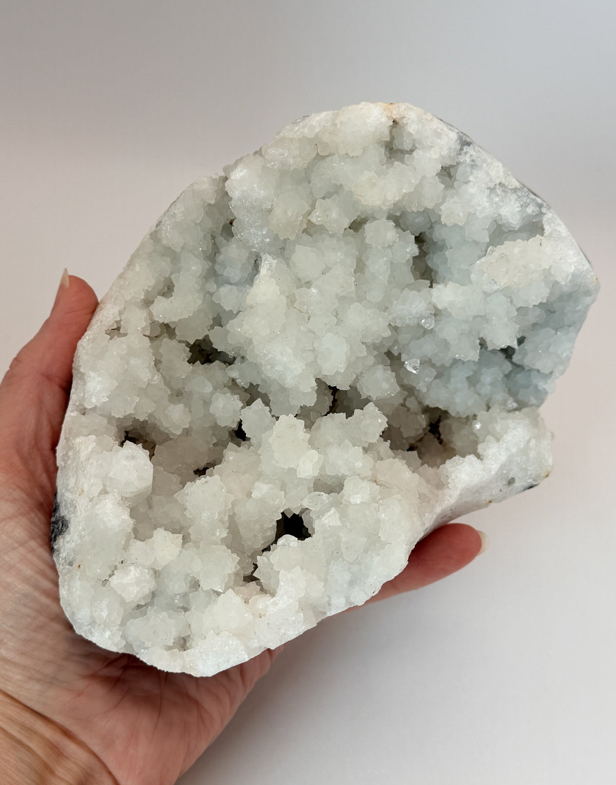 White quartz geode, in hand