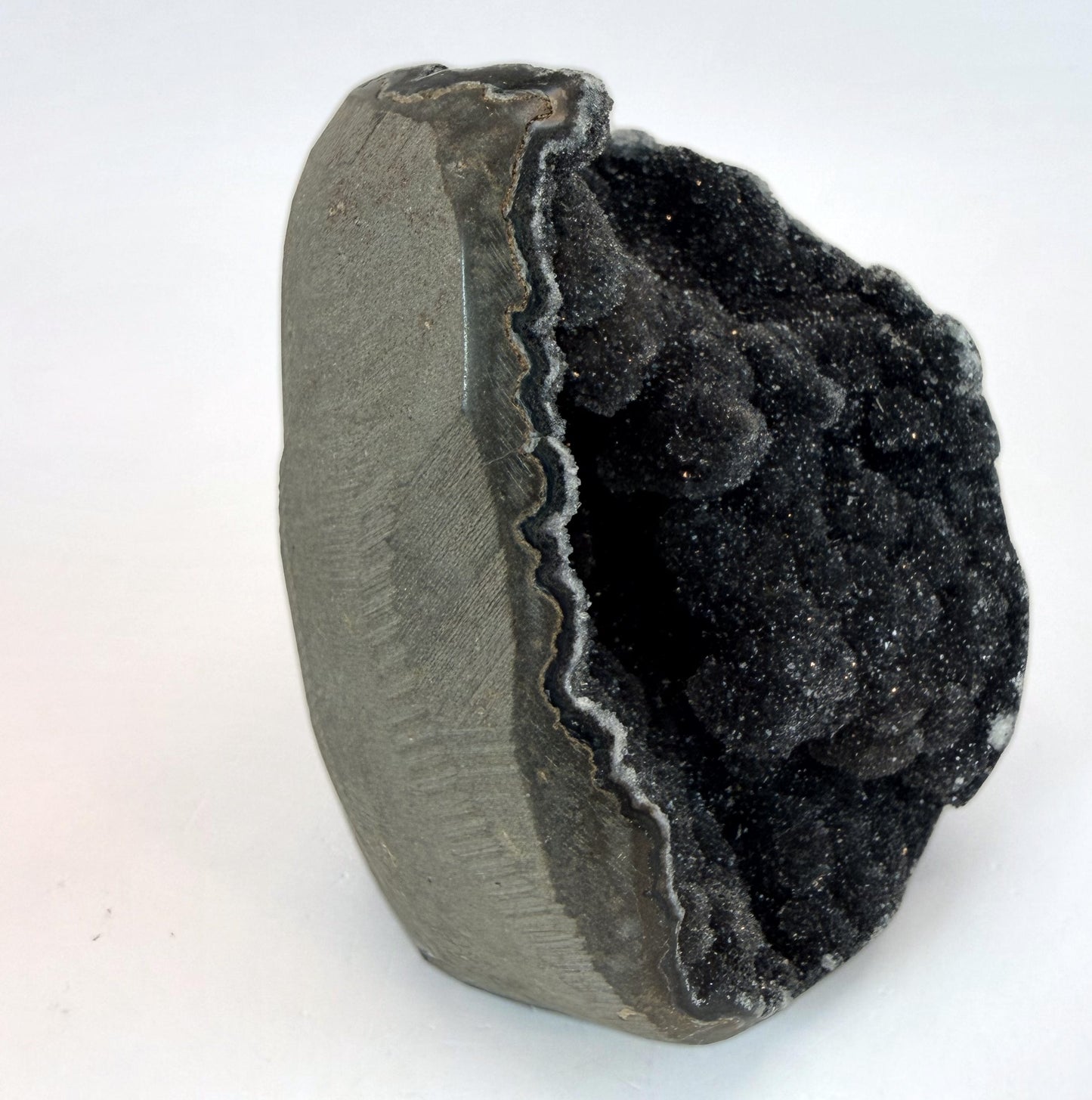 Side view showing the rough gray rock exterior and the agate rim