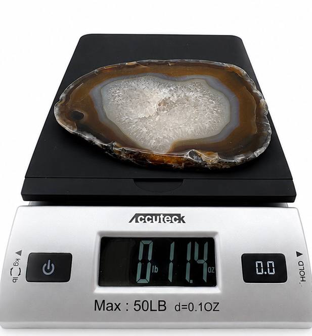 Natural agate slice with druzy quartz center and amber banding on acrylic stand
