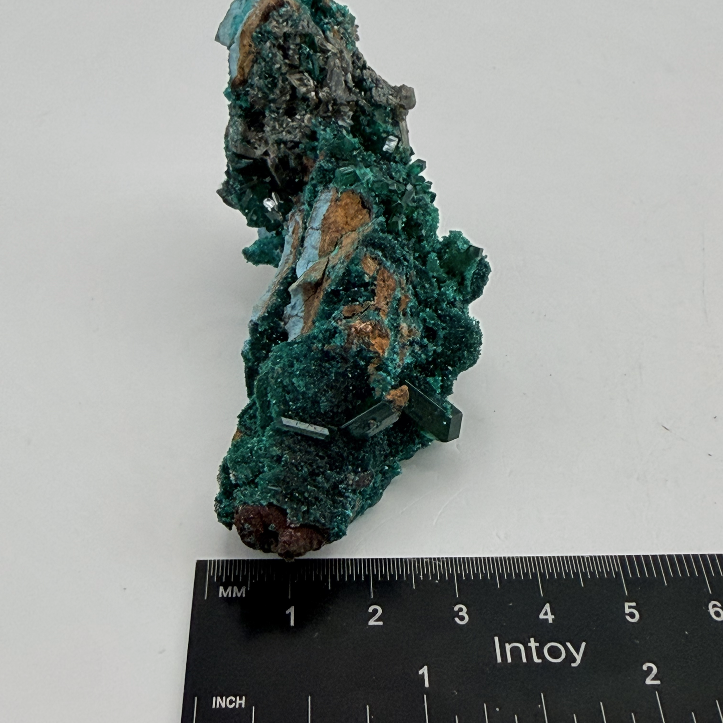 Dioptase specimen with silvery blades