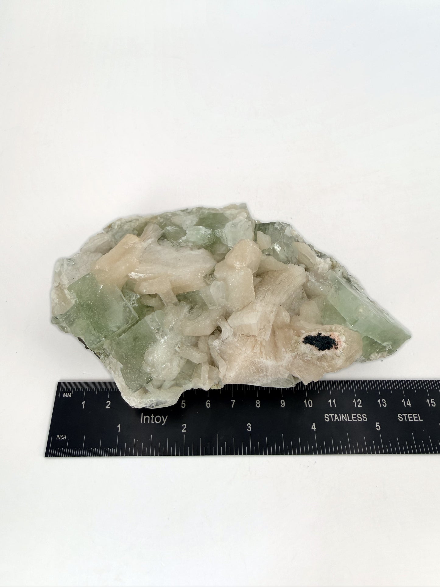 Green apophyllite with peach stilbite, size reference