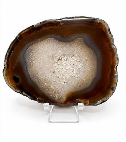 Natural agate slice with druzy quartz center and amber banding on acrylic stand