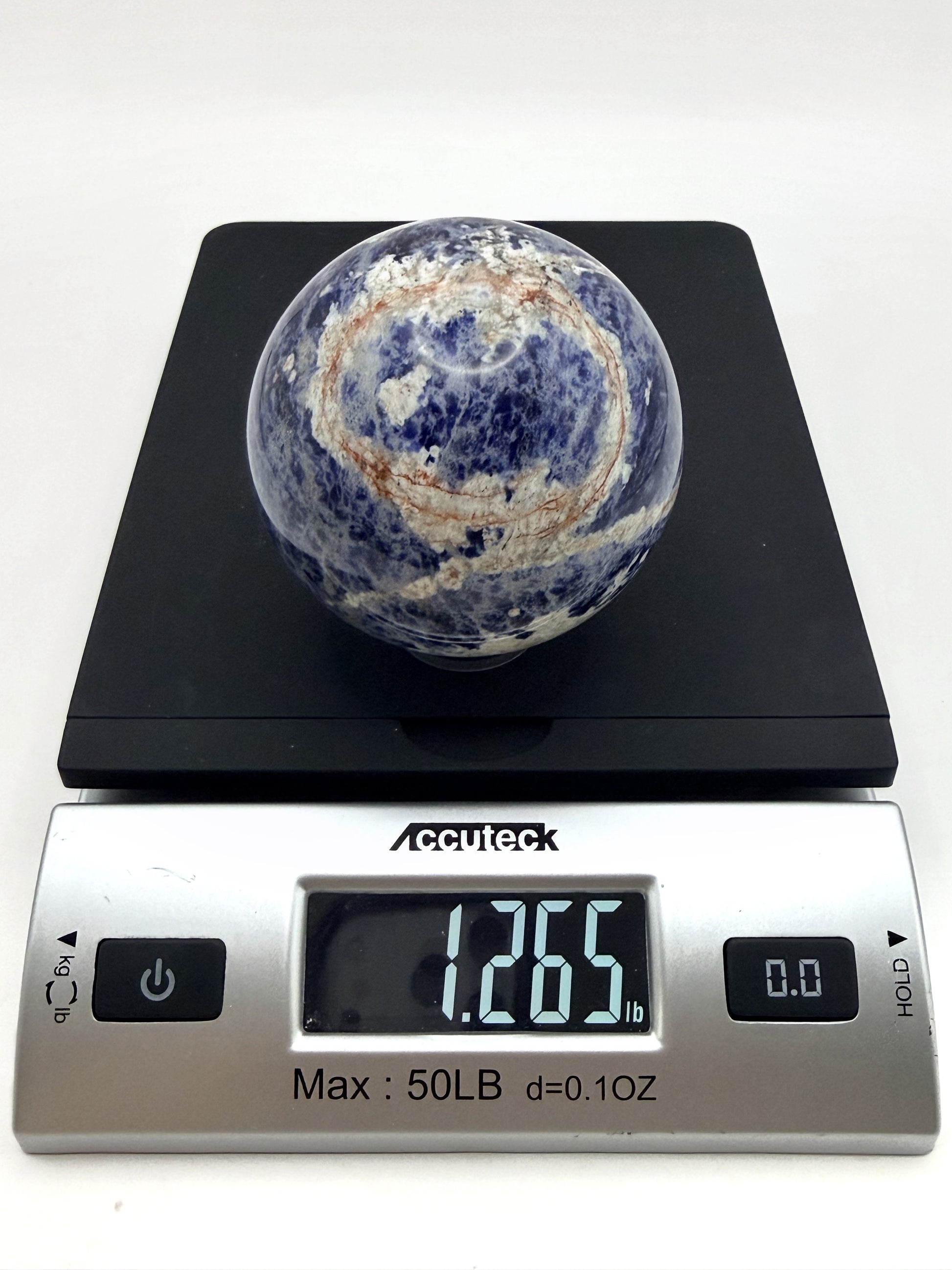 Sunset Sodalite sphere weighed at 1.265 pounds