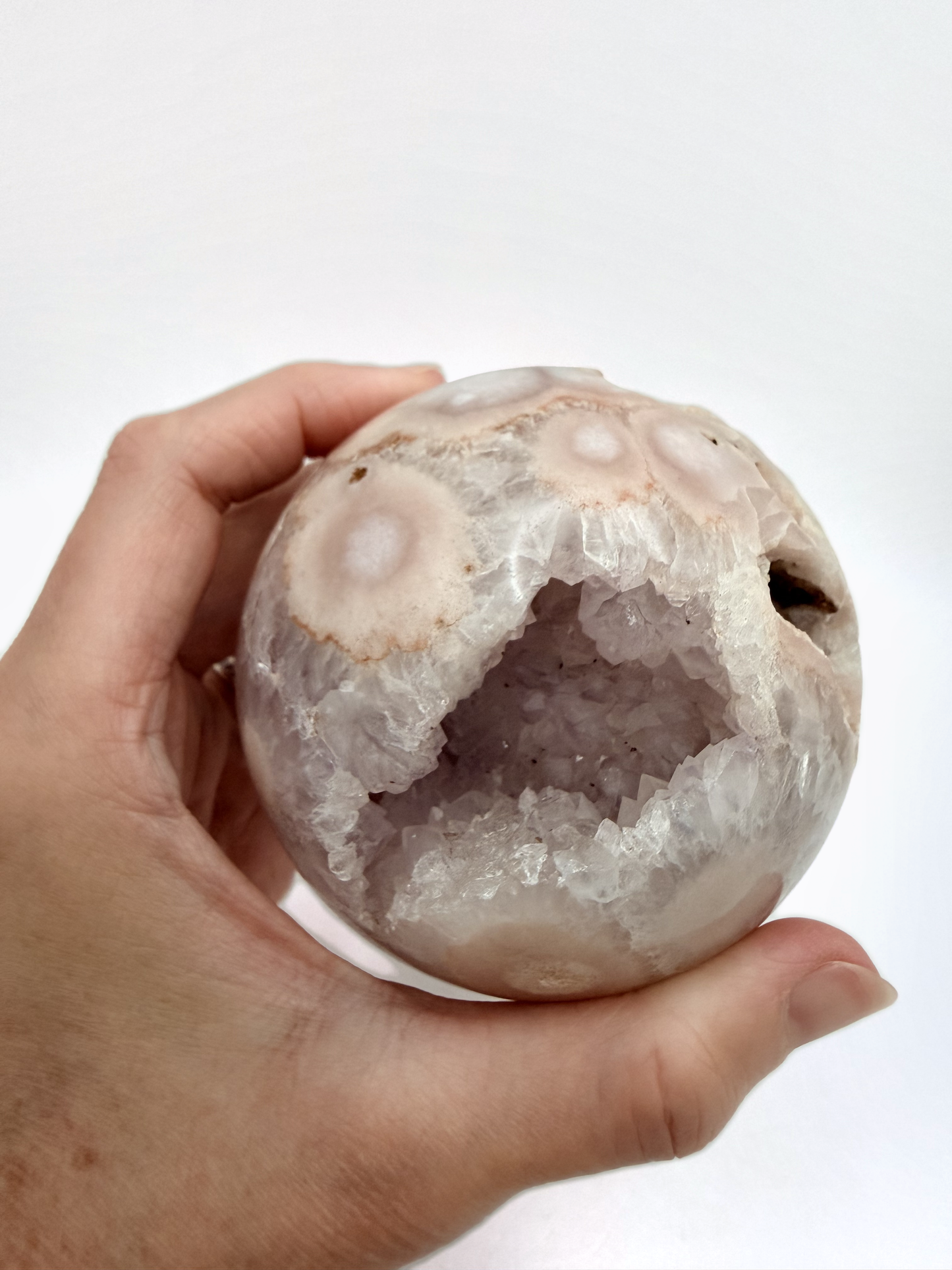 Flower agate sphere with druzy geode pocket