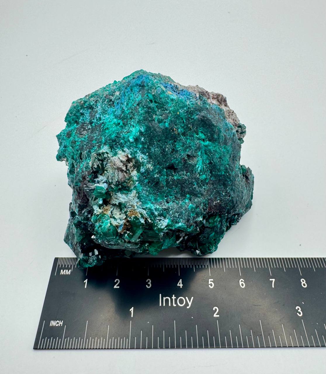 Dioptase crystal specimen with ruler for scale