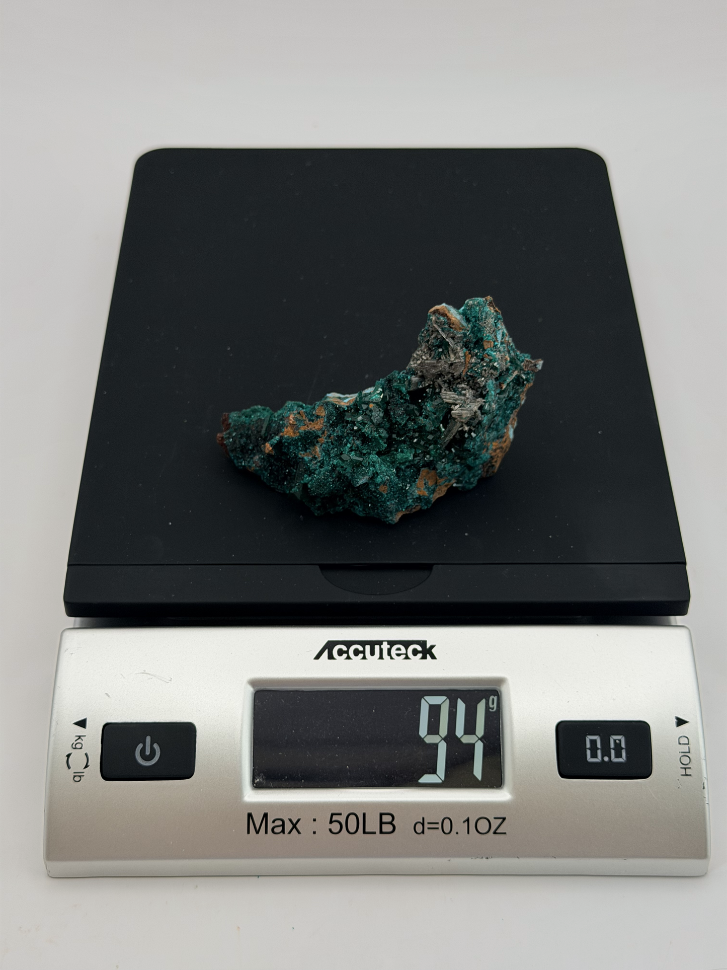 Dioptase specimen with silvery blades