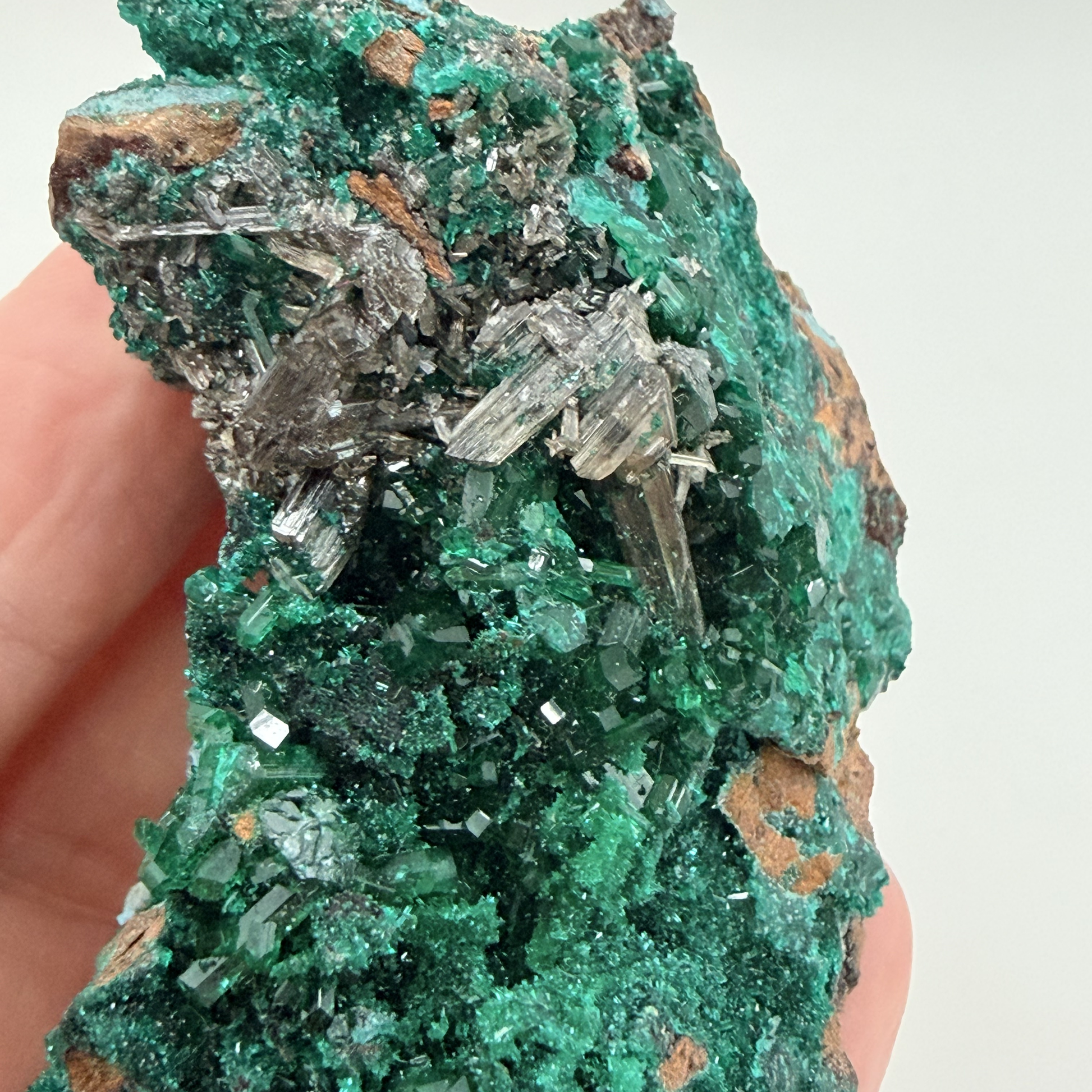 Dioptase specimen with silvery blades