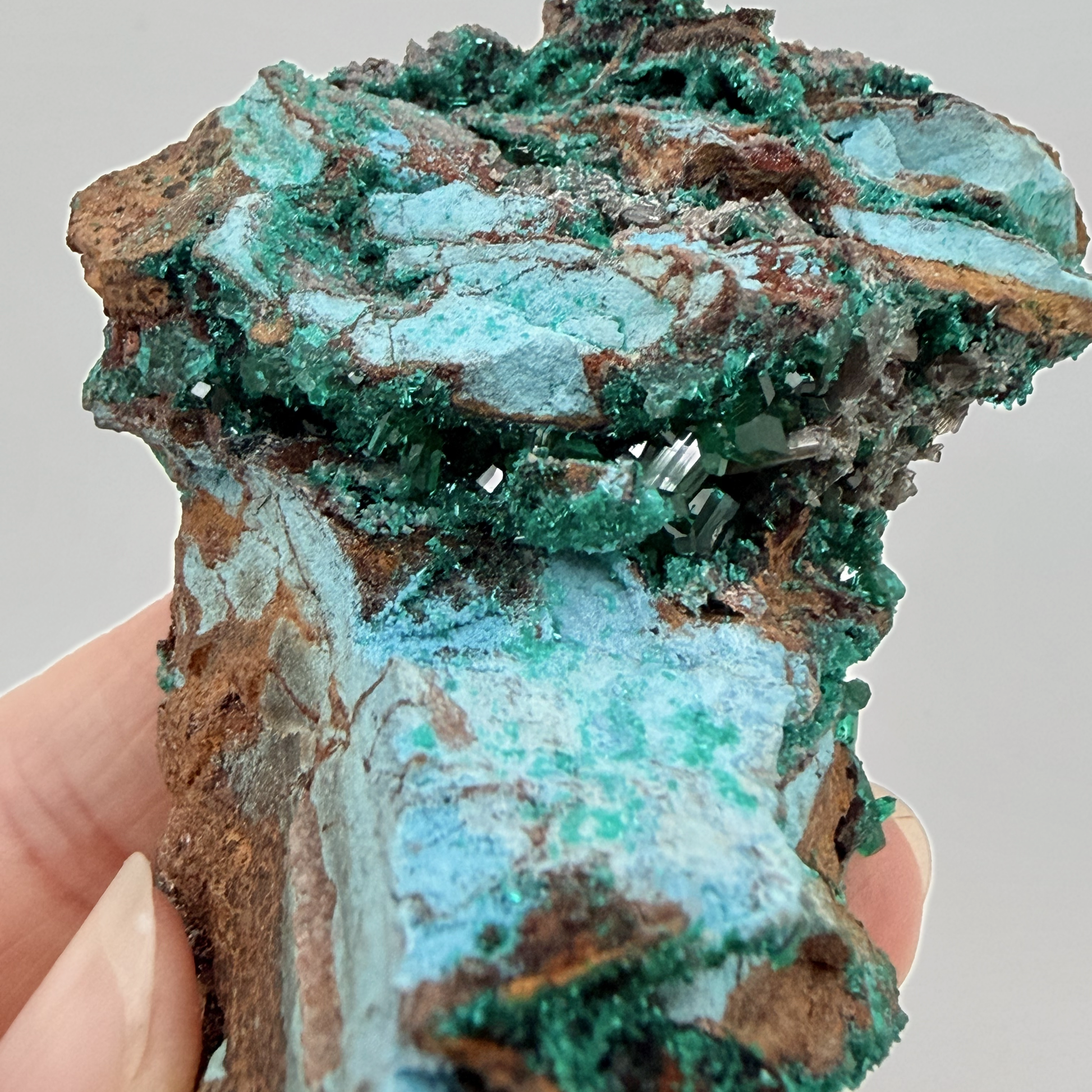 Dioptase specimen with silvery blades