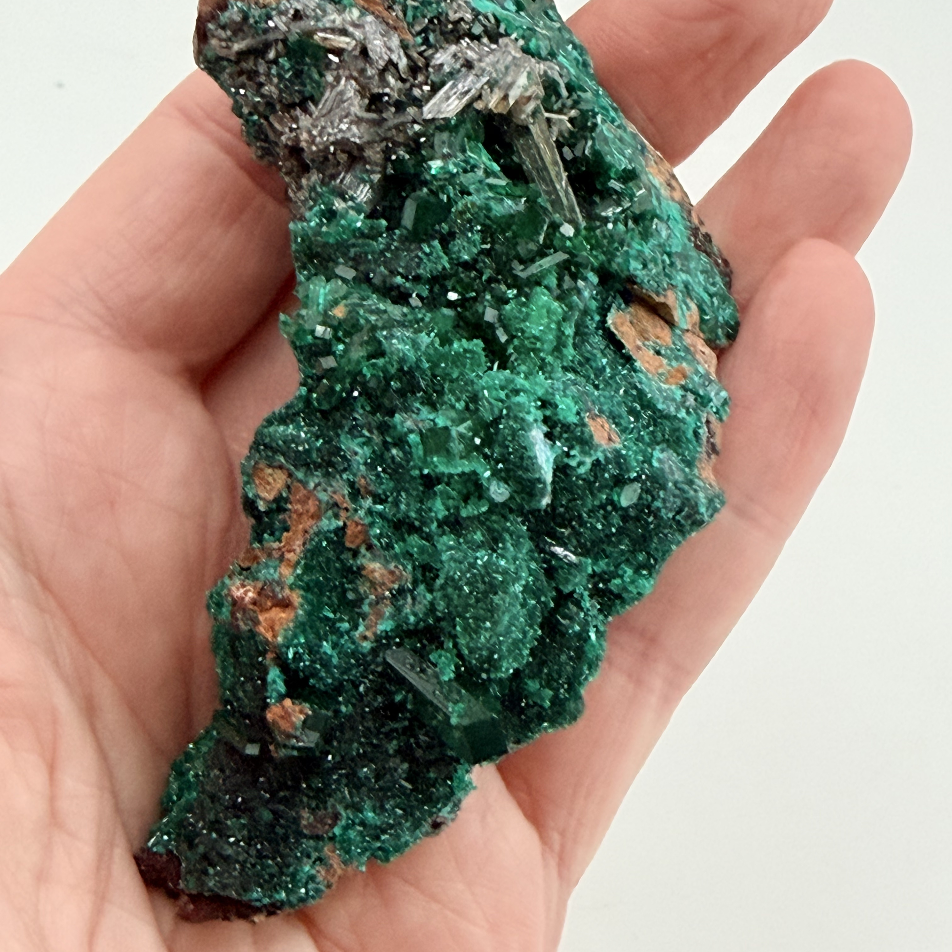Dioptase specimen with silvery blades
