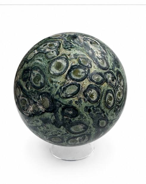 Kambaba Jasper sphere showing orbicular eye patterns on white background
