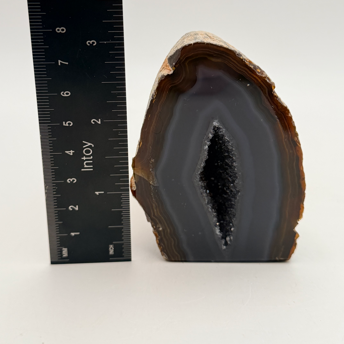 Geode beside a ruler showing 3 inches tall