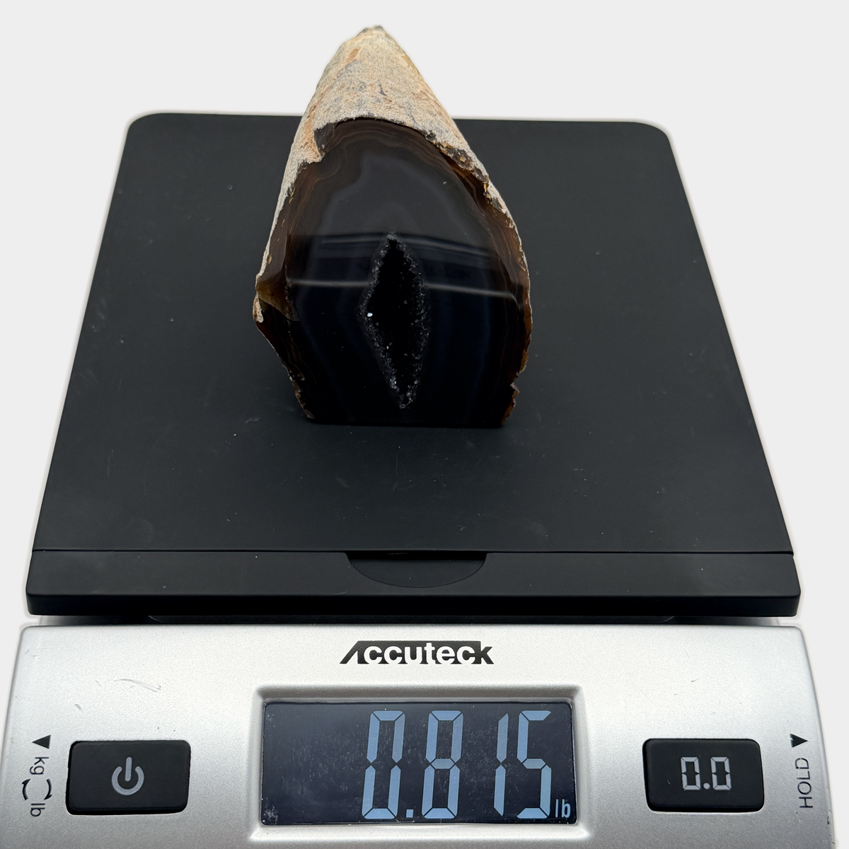 Geode on a scale reading 0.815 pounds