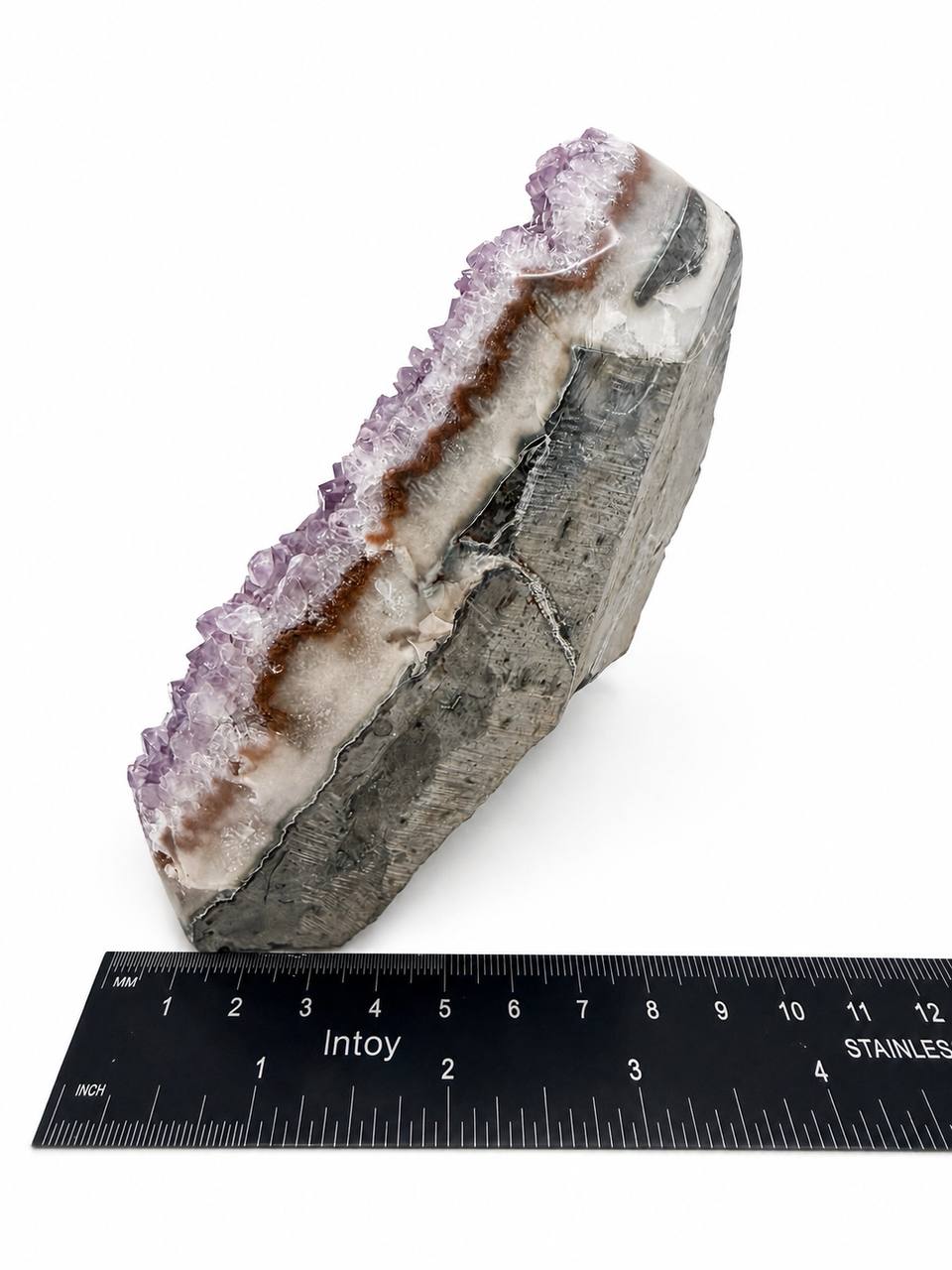 Lavender amethyst cluster side view showing agate banding layers