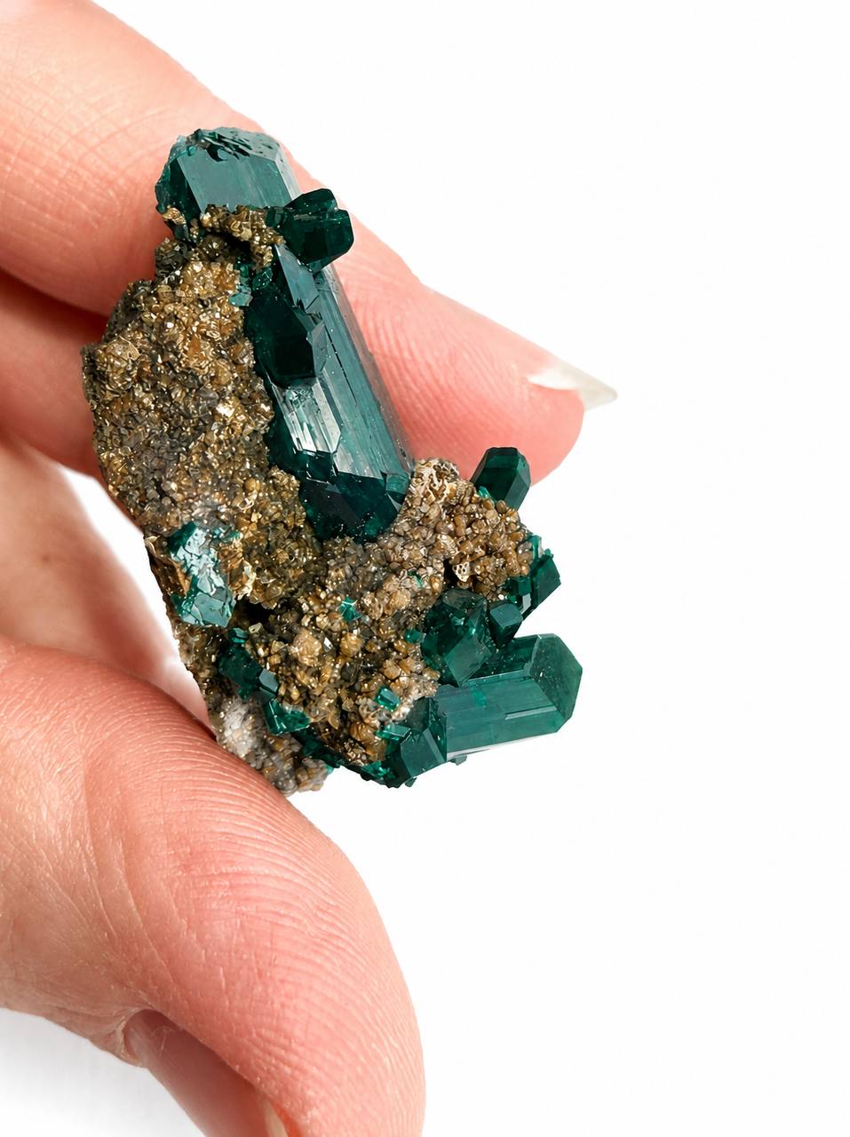 Dioptase crystal blade in hand back view