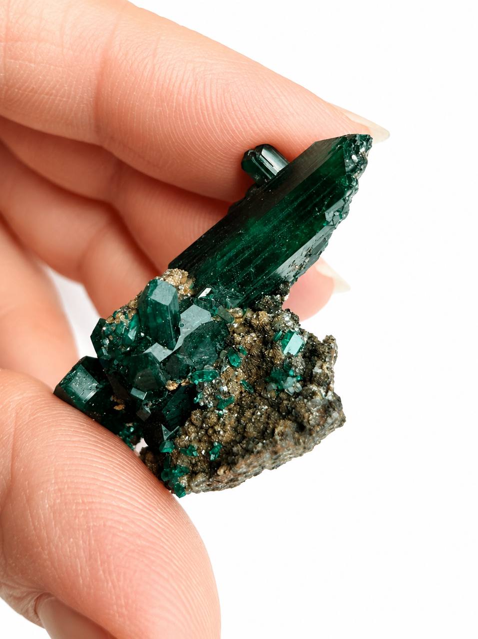 Dioptase crystal blade in hand side angle showing termination