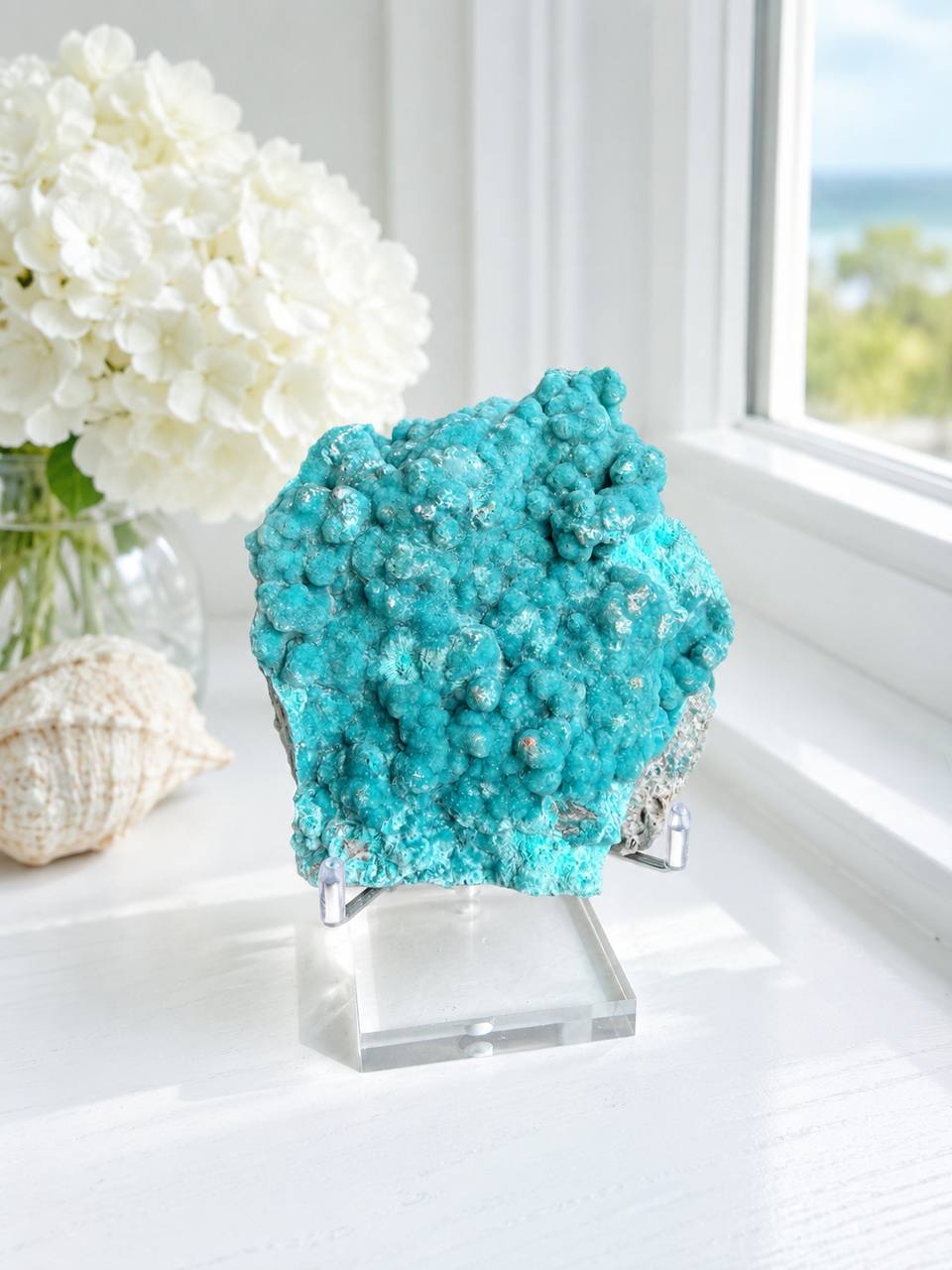 Teal hemimorphite crystal on windowsill lifestyle display