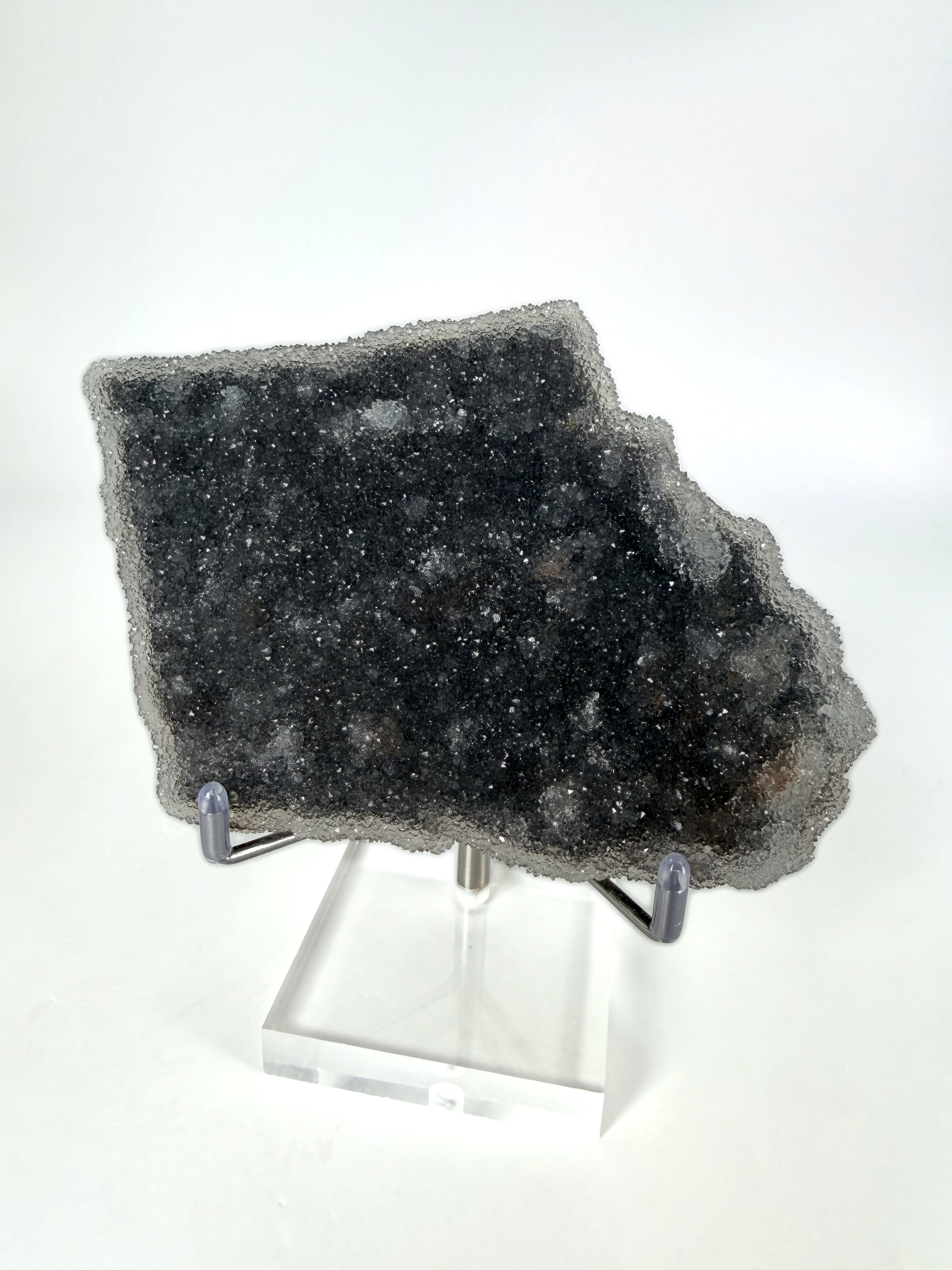 Dark amethyst druzy plate on its acrylic stand