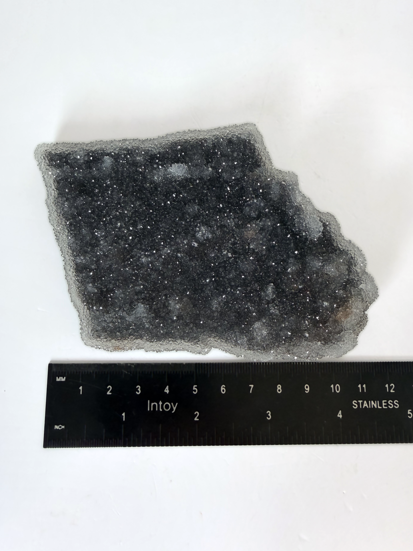 Amethyst druzy plate beside a ruler, 4.5 by 3.5 inches