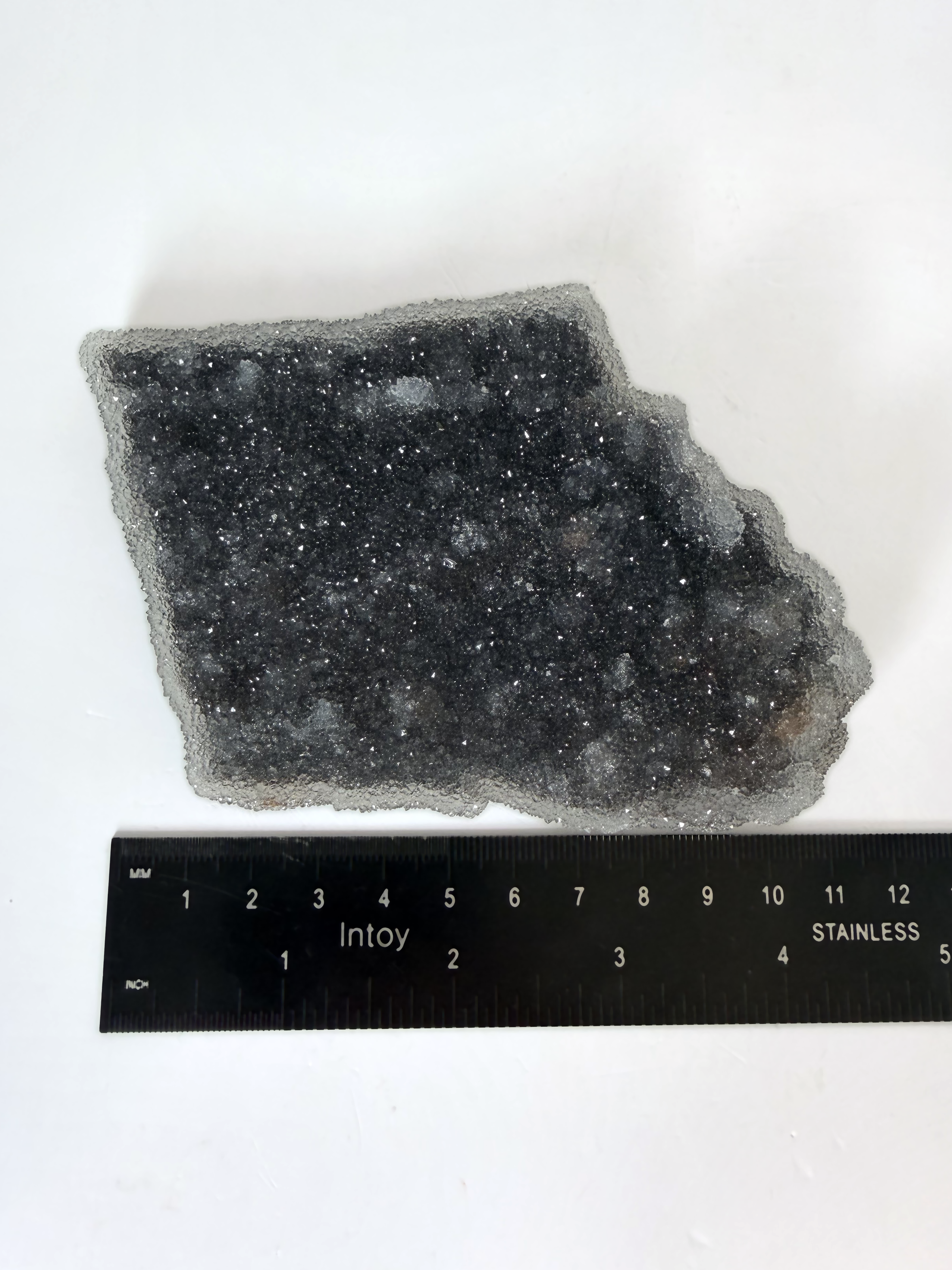 Amethyst druzy plate beside a ruler, 4.5 by 3.5 inches