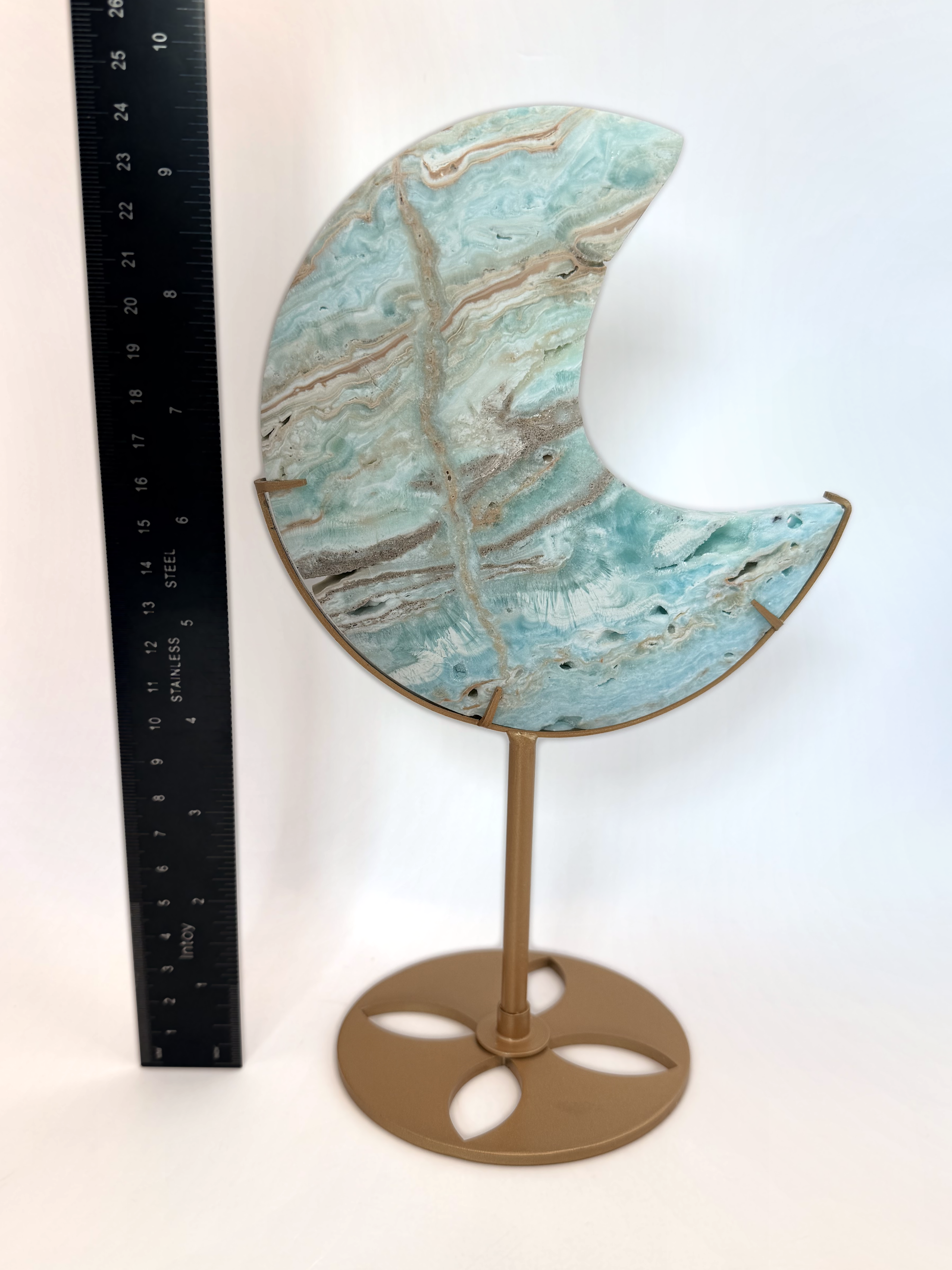 Caribbean calcite moon beside a ruler, 9.5 inches on the stand