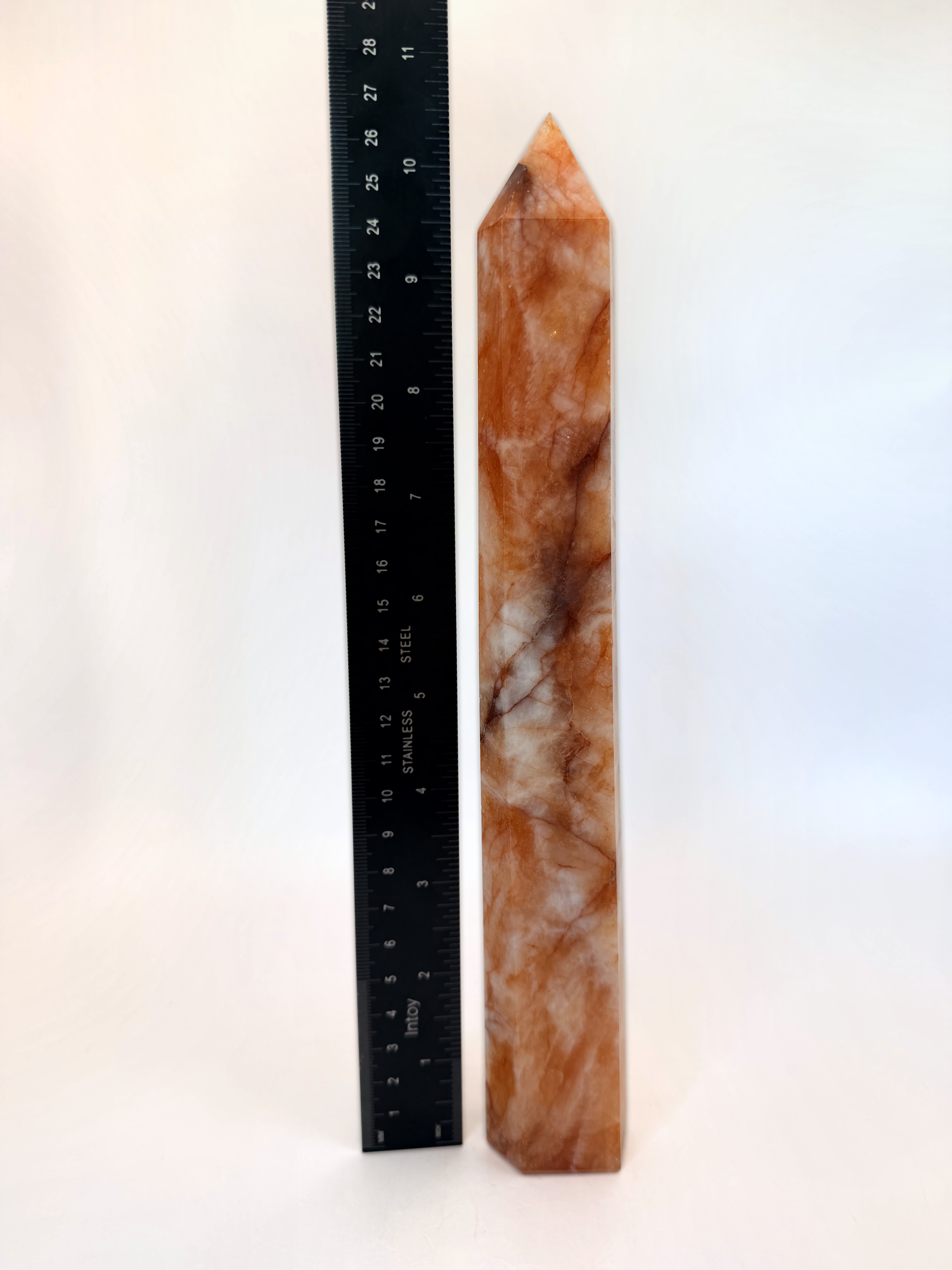 Fire quartz tower beside a ruler, 10.5 inches
