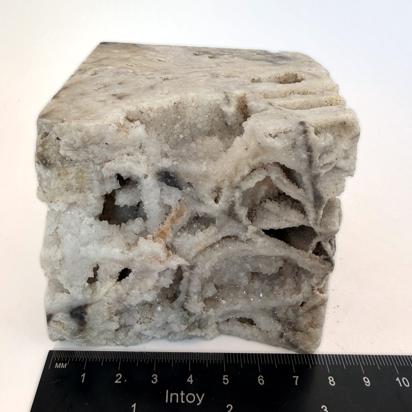 Druzy quartz boxwork specimen beside a ruler, about 3 inches