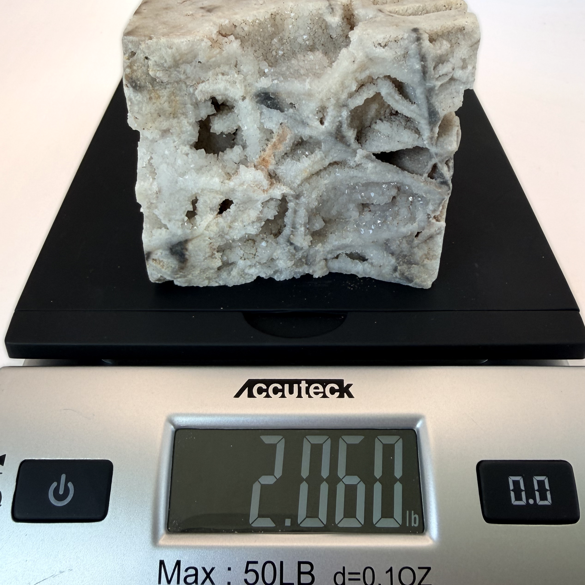 Druzy quartz boxwork specimen on a scale, 2.060 lb