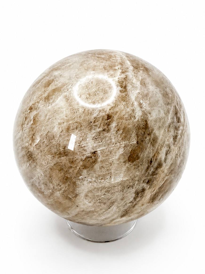 Peach moonstone sphere on white background - side view