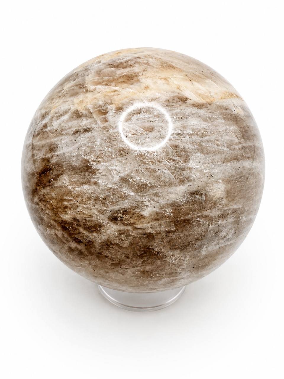 Peach moonstone sphere on white background - showing natural patterns