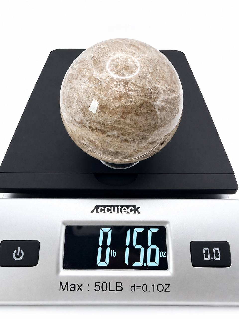 Peach moonstone sphere on scale showing 15.6 oz weight