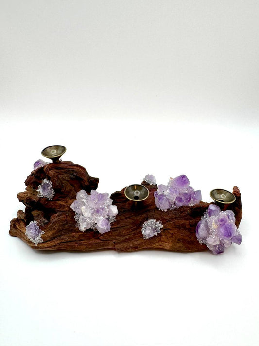 Purple fluorite crystal sphere holder showing three brass cups on driftwood base