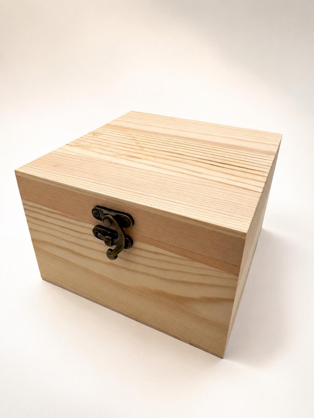 Wooden keepsake box with brass clasp closed