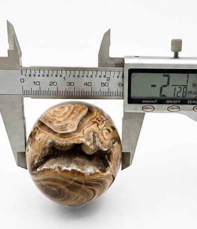 Chocolate calcite sphere 2.1 inch diameter caliper measurement